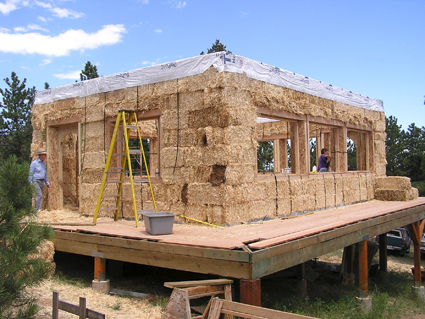 Construction d'une maison en ballots de paille sur poteaux.  JPEG - 166.9 ko